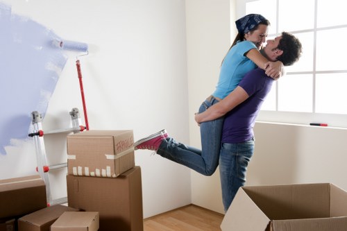 Professional movers handling office equipment